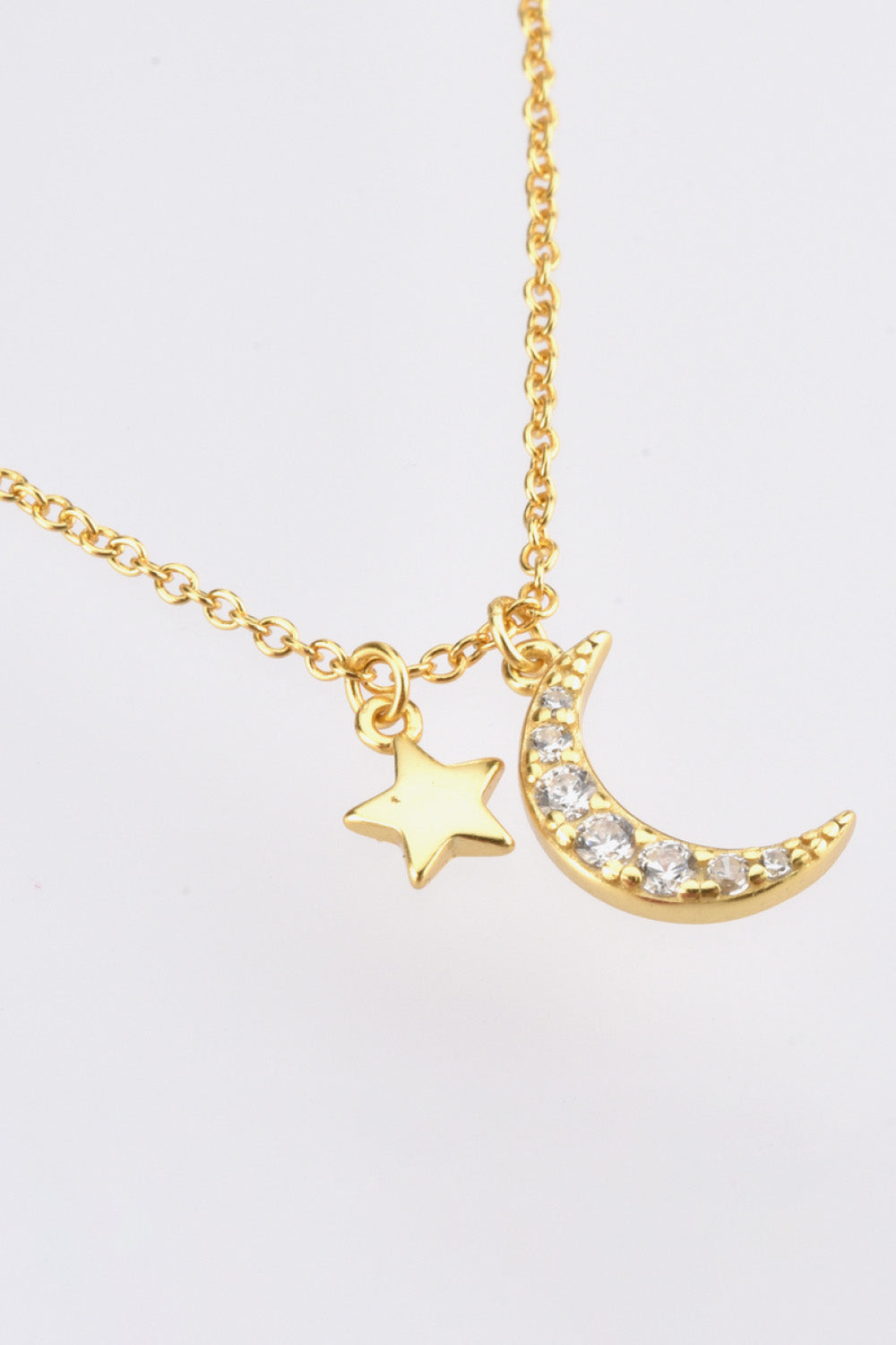 Zircon pendant necklace, star and moon design, celestial jewelry, fashion accessory, statement piece, elegant necklace, glamorous accessory, celestial theme, dainty details, versatile necklace
