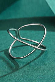 Sterling silver ring, Open design, Crisscross ring, Elegant jewelry, Unique silver ring, Contemporary design, Adjustable silver ring, Fashionable accessory, Fine silver jewelry, Statement piece.