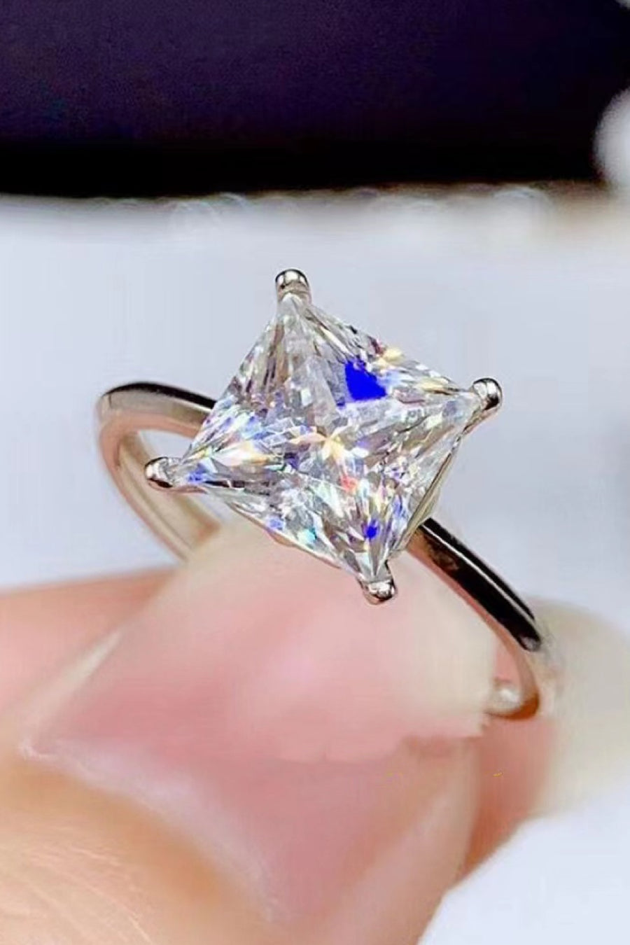 Moissanite solitaire ring, Lab-created gemstone, 5-carat statement piece, Sparkling centerpiece, Timeless elegance, Luxury jewelry, Classic design, High-quality craftsmanship, Affordable glamour, Fine jewelry accessory.